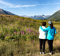 Two people looking out at nature. Links to Gifts of Real Estate