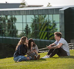 Students sitting on the ground. Links to UAA Announces Largest Estate Gift in University History