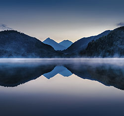 A view of mountains and a lake. Links to Closely Held Business Stock