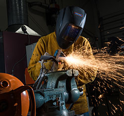 A student welding. Links to Gifts That Pay You Income