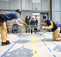 Two men building an object. Links to Tangible Personal Property