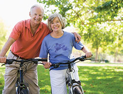 Photo of a man and woman on bicycles. Link to Life Stage Gift Planner Ages 60-70 Situations.